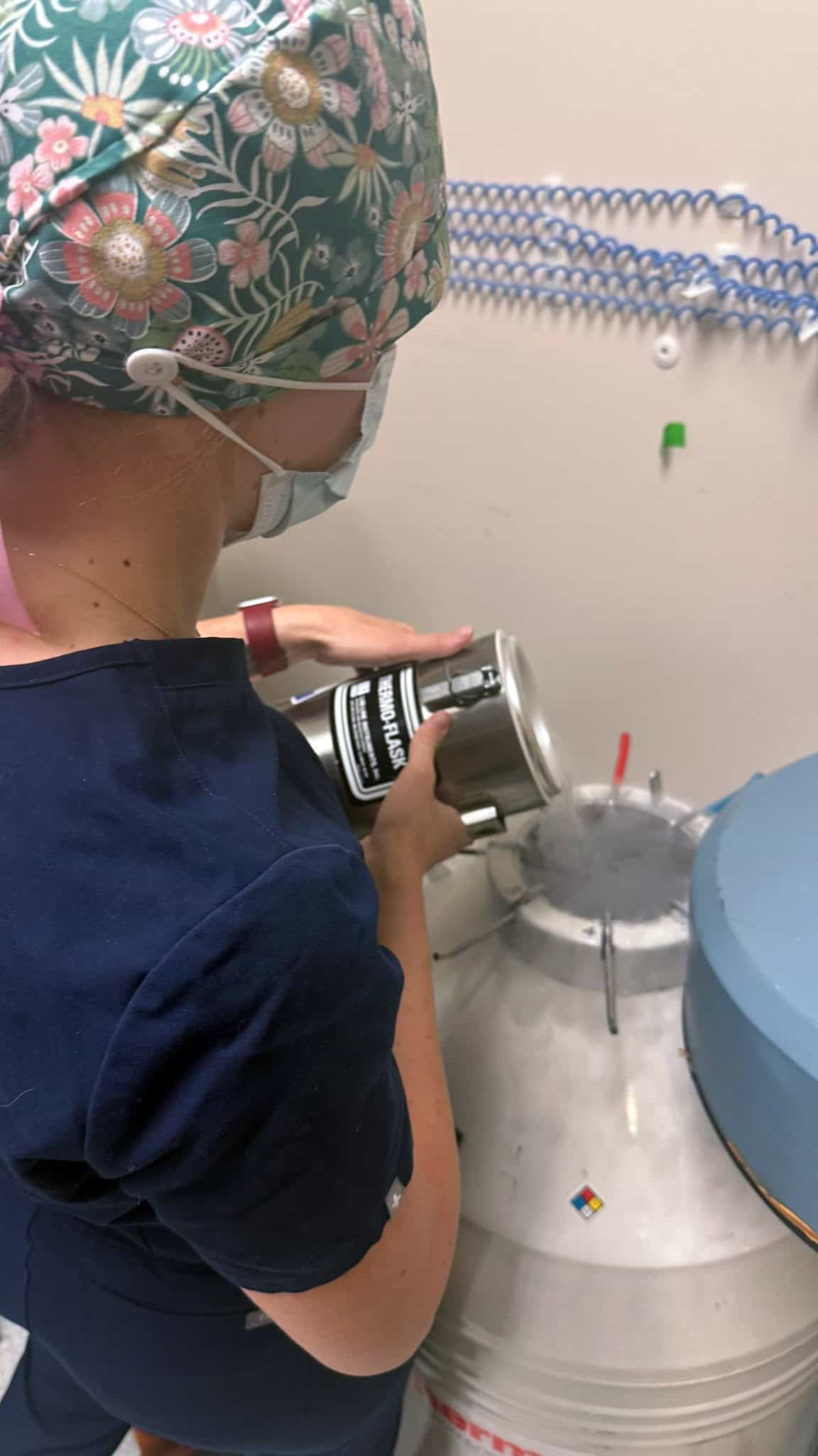 Embryologist Filling Frozen Embryo Tank at FTC